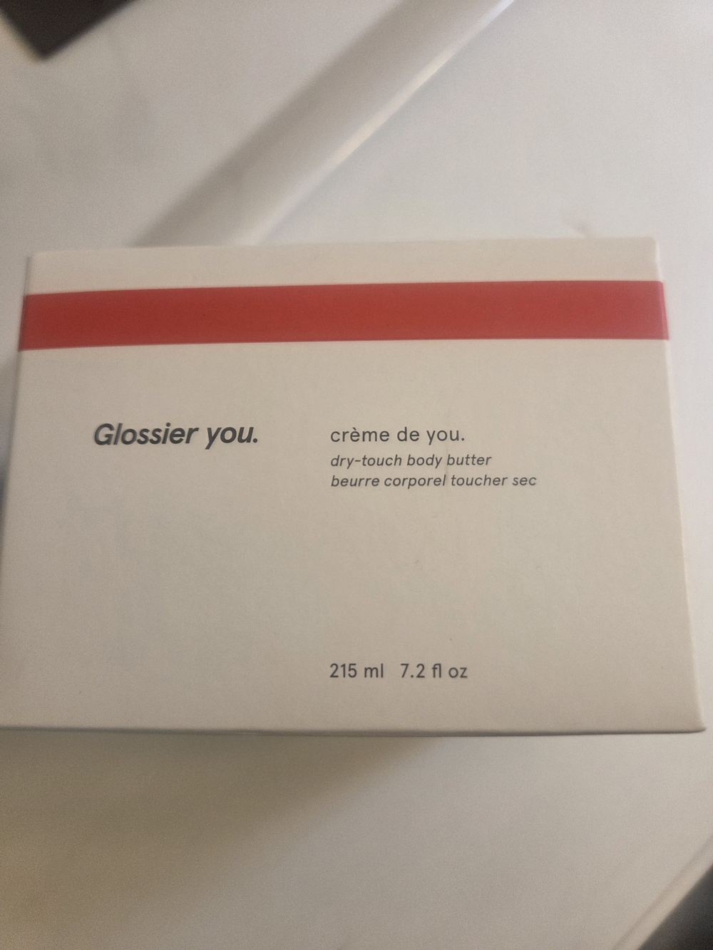 Glossier cream white with red stripe